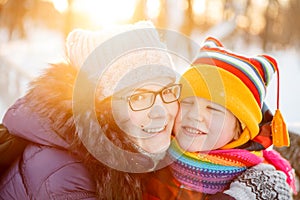 Mom and child in winter wonderland scene. Mother and baby in wintertime magic. Family on a walk in the Christmas and New Year