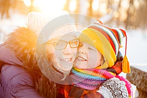 Mom and child in winter wonderland scene. Mother and baby in wintertime magic. Family on a walk in the Christmas and New Year