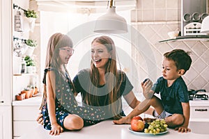 Mom with children eating on the kitchen table