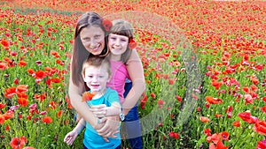 Mom with children in a field of poppies