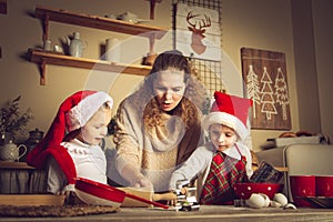 Mom and children are preparing cookies in the kitchen