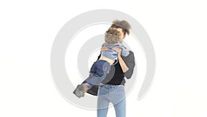 Mom circles around her son, he laughs. White background. Slow motion