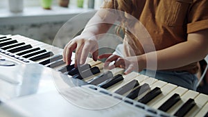 Mom communicates with grandparents on a laptop and shows how her daughter plays the synthesizer