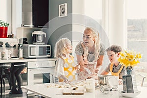 Mom cooking with kids on the kitchen