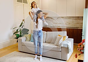 Mom and cute little daughter playing and laughing together at home