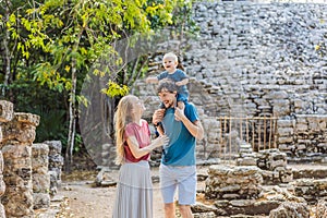 Mom, dad and baby tourists at Coba, Mexico. Ancient mayan city in Mexico. Coba is an archaeological area and a famous