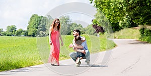 Mom, dad and daughter having walk on path