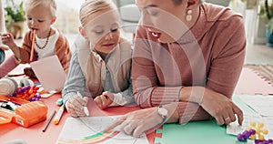 Mom, dad and kids drawing on living room floor for bonding, teaching and learning together. Color pencil, paper and