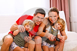 Mom and dad playing with daughter on console