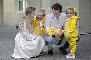 Mom and dad show the children a newborn baby