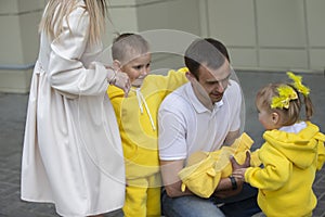 Mom and dad show the children a newborn baby