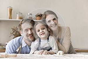 Mom, dad and toddler kid with funny floury facial masks