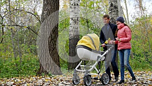 Mom and Dad are walking in the woods with a newborn baby