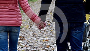 Mom and Dad are walking in the woods with a newborn baby