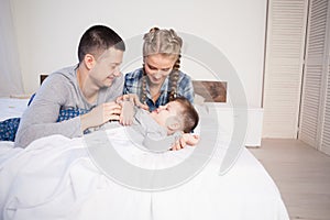 Mom dad and young son in the bedroom after sleeping House