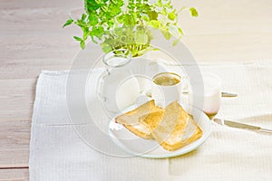 Mom and daughter breakfast in bed on a white blanket