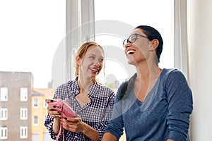 Mom and daughter chatting and laughing at home