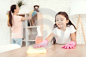 Mom and daughter are cleaning at home. Wipe the shelves and the table.