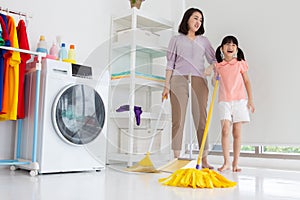 Mom and daughter cleaning house doing chore work at home