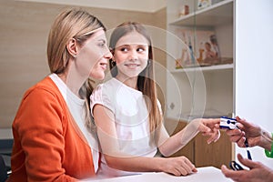 Mom and daughter in a clinic at a pediatricians appointment