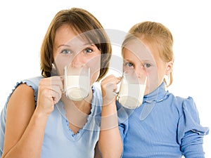 Mom and daughter drink milk.