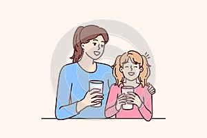 Mom and daughter drink natural milk to get useful vitamins and lactose or calcium from eco product