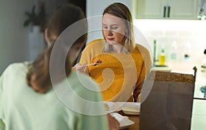 Mom and daughter eat sushi