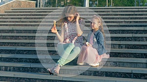 Mom and daughter eating ice cream in a park. mother and child. relaxing happy family