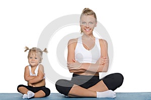 Mom and daughter engage in fitness on mat