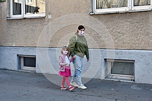 Mom and daughter with facemasks against coronavirus.