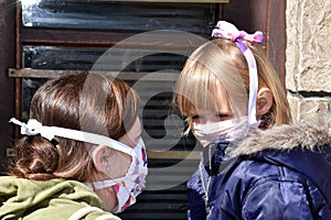 Mom and daughter with facemasks against coronavirus.