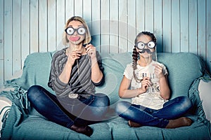 Mom and daughter with false mustaches