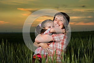 Mom and daughter family at sunset