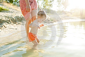 Mom and daughter first learn to swim. Summer vacation. Family holiday. Mom and daughter