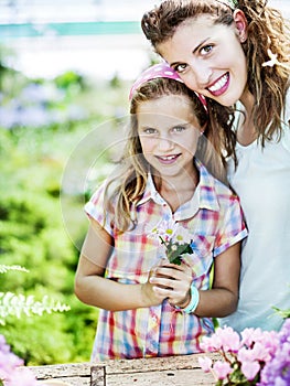 Mom and daughter have fun in the work of gardening