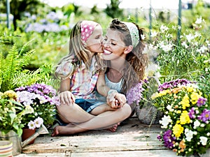 Mom and daughter have fun in the work of gardening