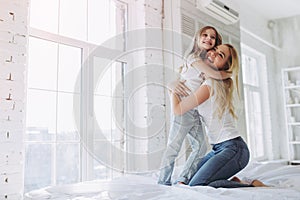 Mom and daughter having fun at home