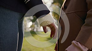 Mom daughter holding hands in sunny park together closeup. Happy mother child.