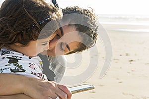 Mom and daughter hugged on the beach