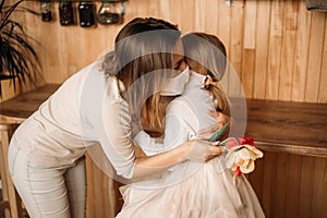 Mom and daughter hugging in masks. Family quarantined. Mother`s day at home