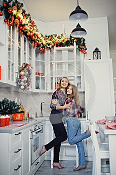 Mom and daughter in the kitchen. Winter holidays at home.