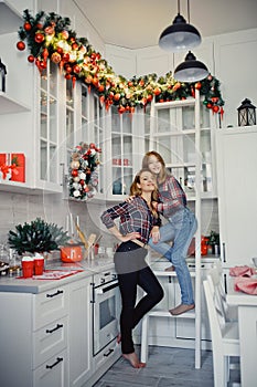 Mom and daughter in the kitchen. Winter holidays at home.