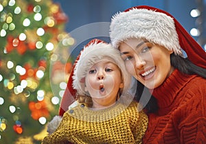 Mom and daughter near the Christmas tree