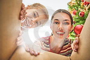 Mom and daughter opening a Christmas present