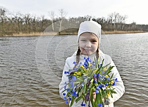 Mom and daughter pick the first spring flowers.