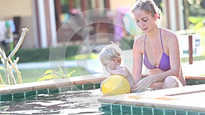 Mom and Daughter Play in the Swimming Pool