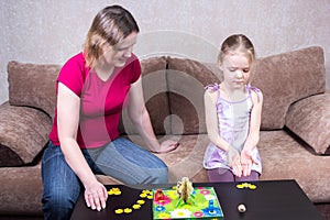 Mom and daughter playing table game