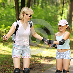 Mom and daughter ride on roller skates