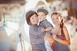 Mom, daughter and son rest in the summer on the beach