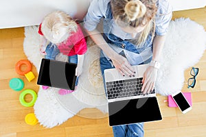 Mom and daughter using tech gadgets together